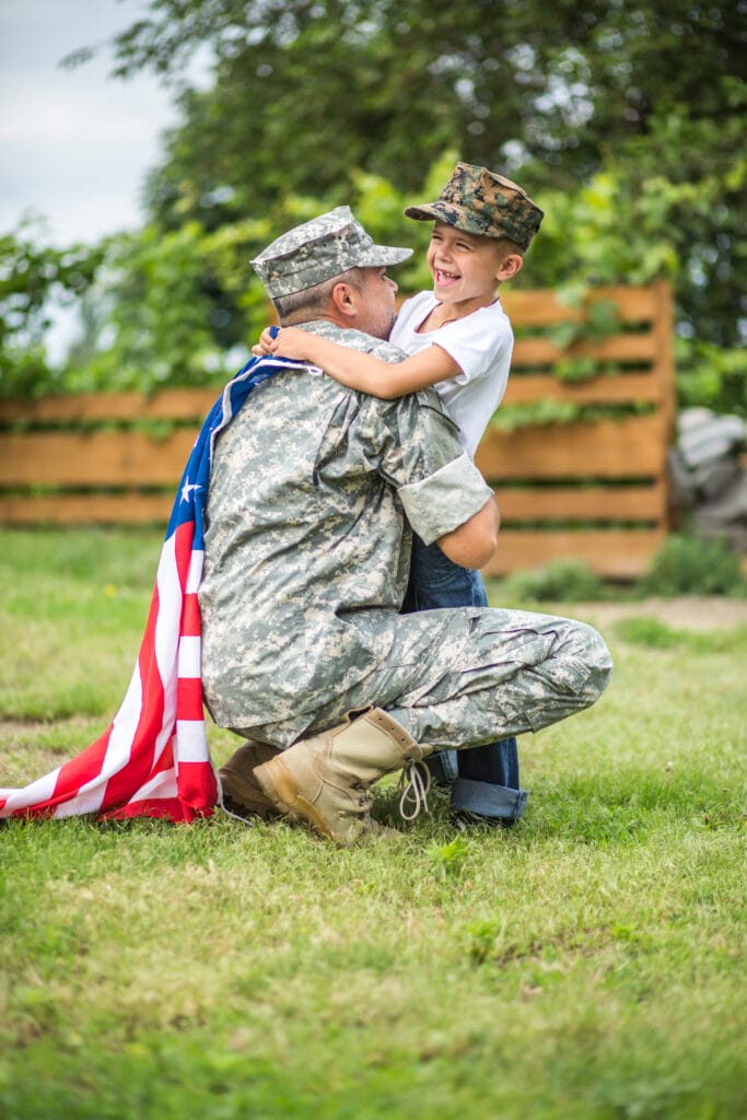 little boy giving a hug to a g.i.