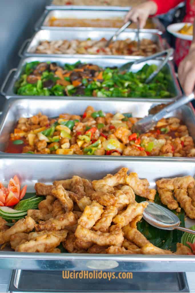 buffet table with vegetables and chicken