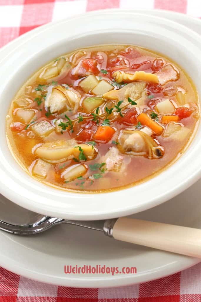 Bowl of Manhatten Clam Chowder on a red and white table cloth