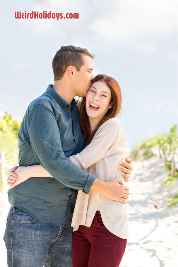 man kissing a ginger haired woman