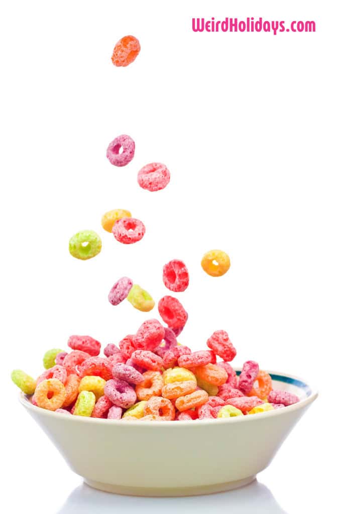 colorful cheerios being poured into a white bowl