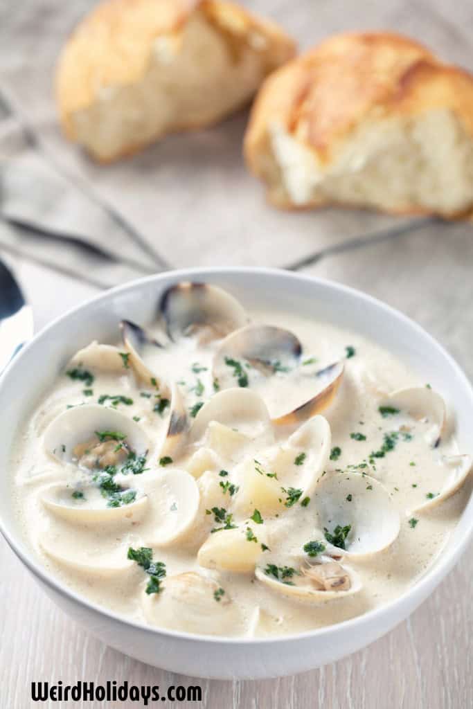 bowl of clam chowder with some bread