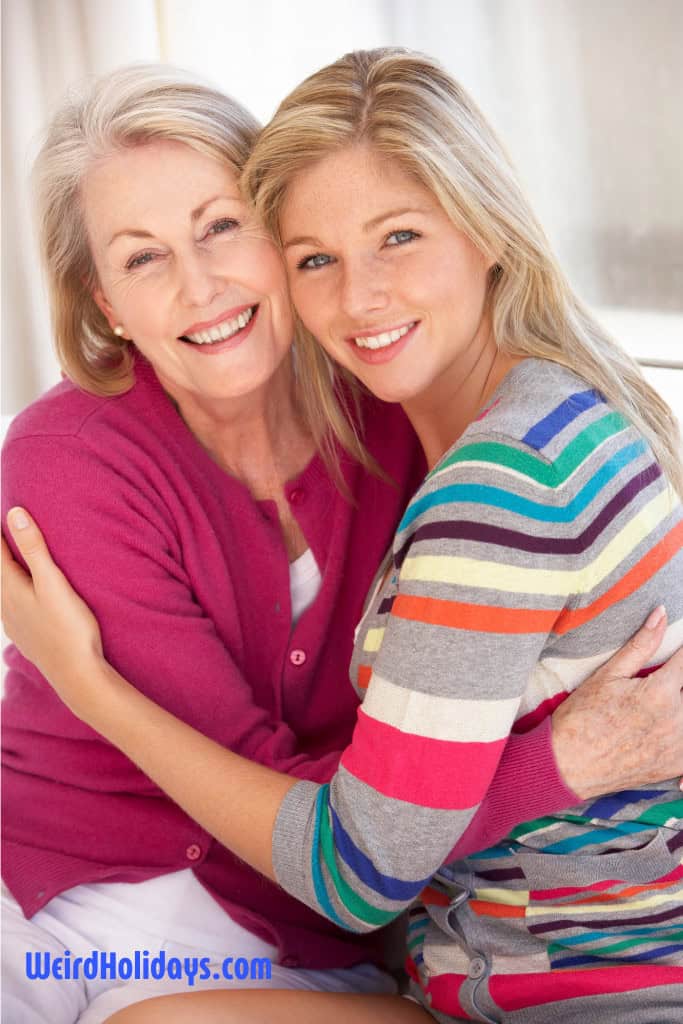 mature woman hugging a younger woman smiling