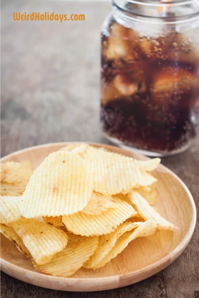 bowl of potato chips and a coke in a glass in the background