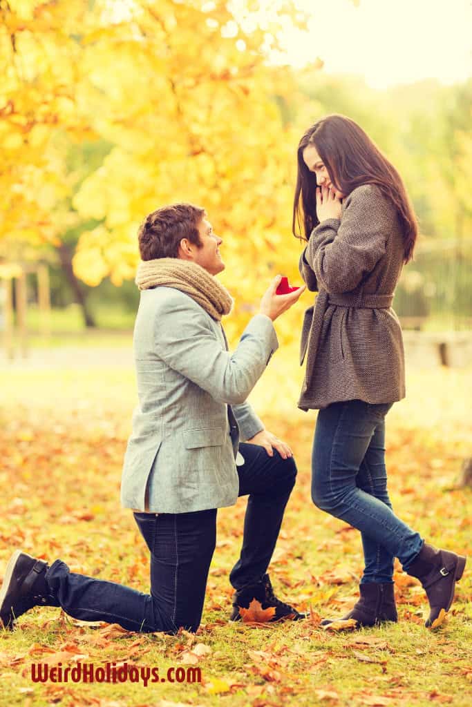 man on one knee proposing to his girlfriend