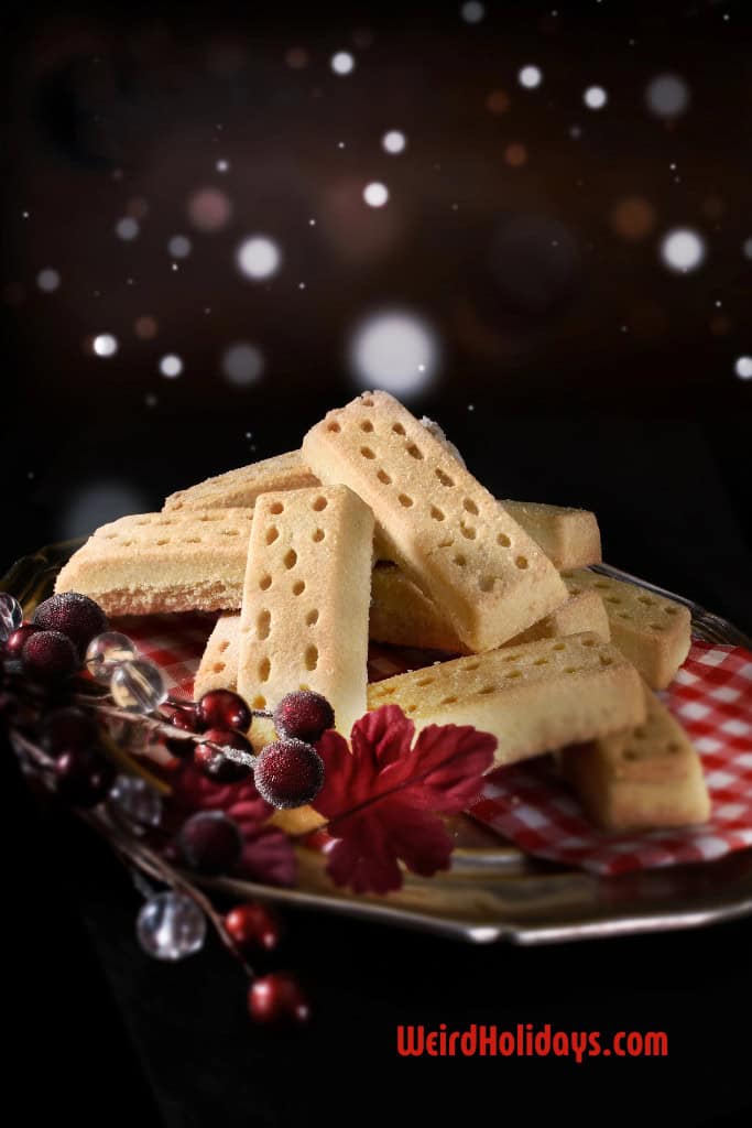 shortbread sticks on a plate with cranberry decorations