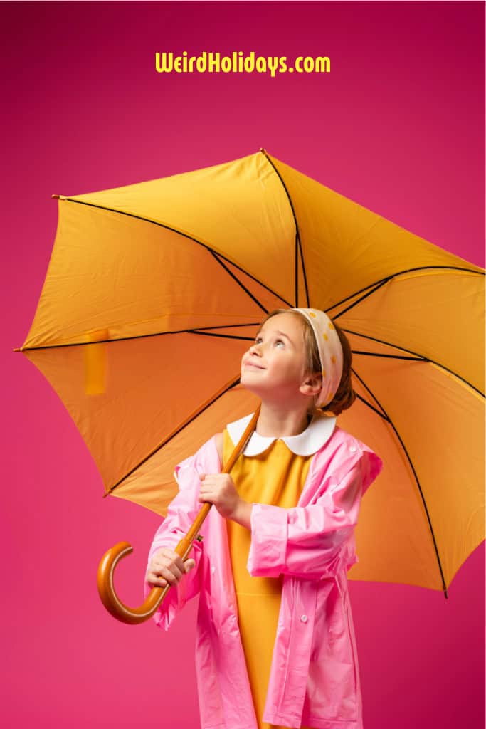 a girl wearing a pink coat holding a yellow umbrella with a bright pink background