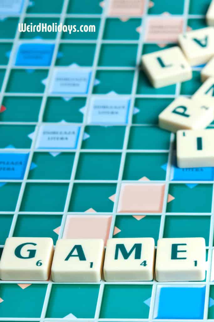 scrabble board with the word game spelled out