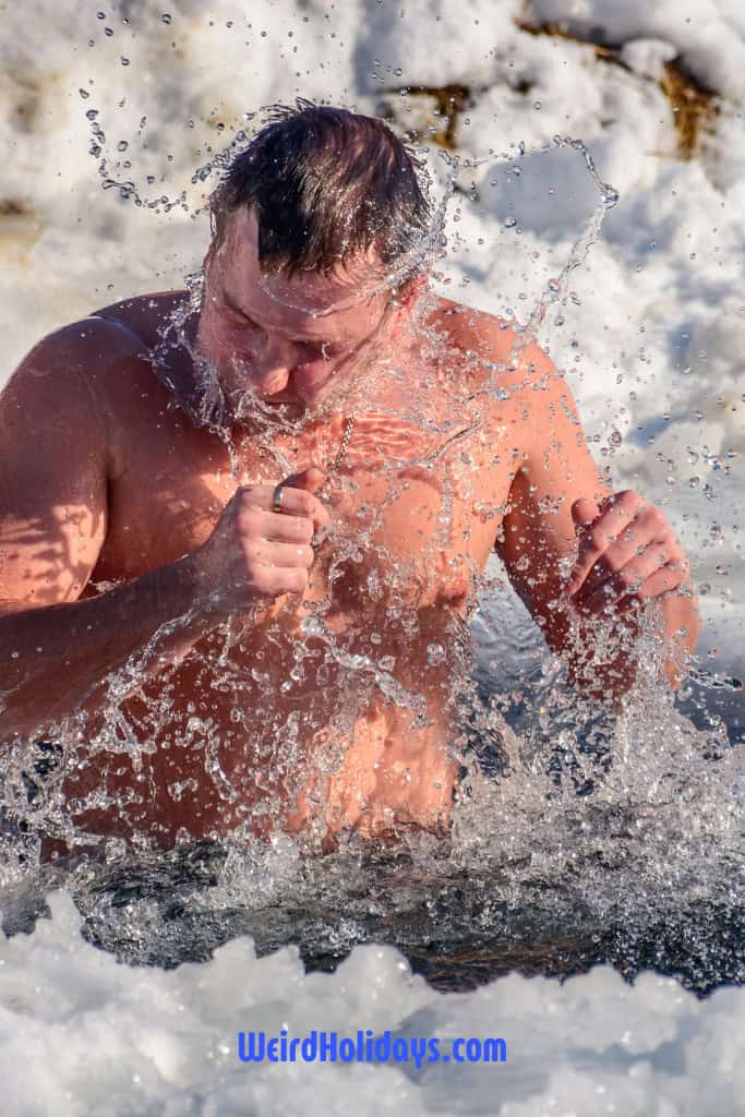 man jumping into freezing water 