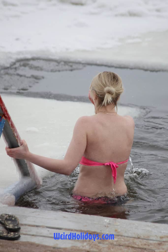 woman walking into freezing water