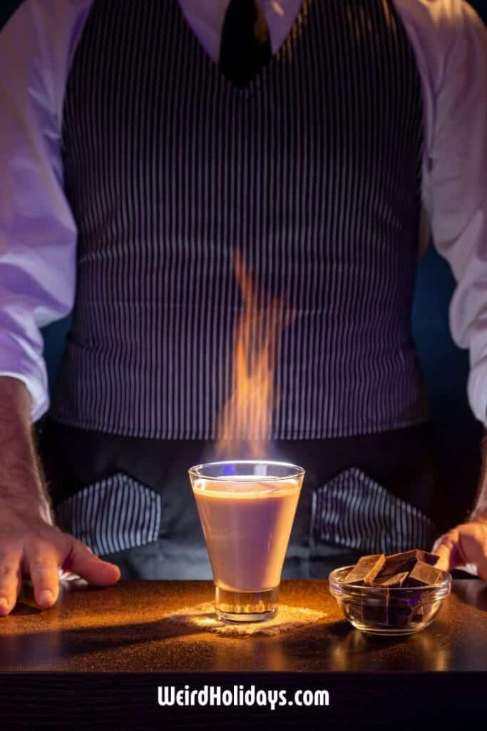 bartender looking at a flaming cocktail