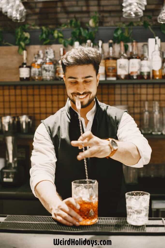 male mixologist stirring a cocktail